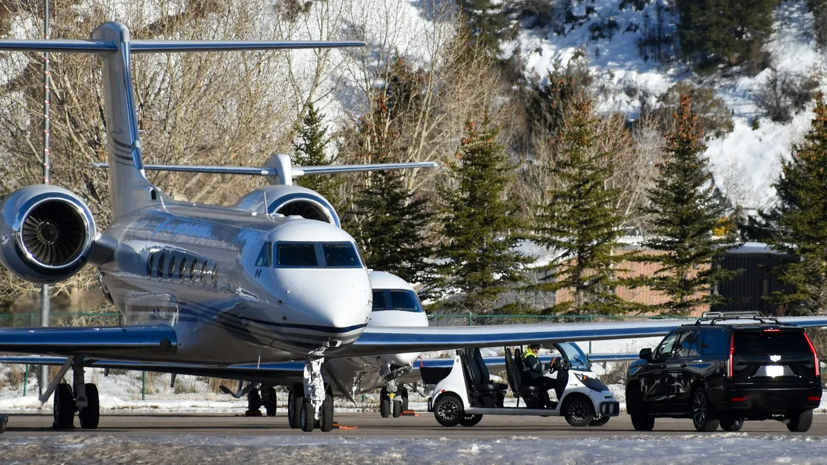 A private jet parked on a snowy mountain ramp
