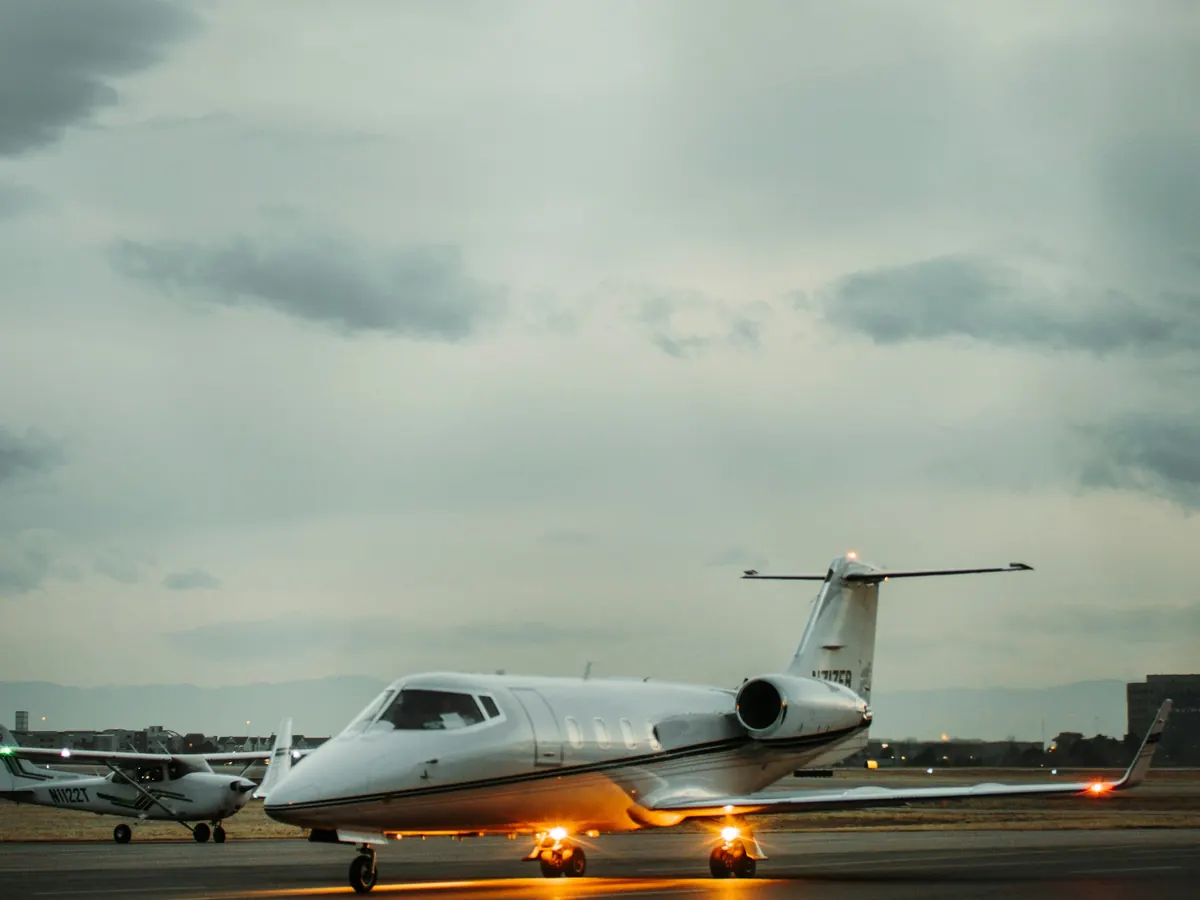 A light jet taxiing with its lights on