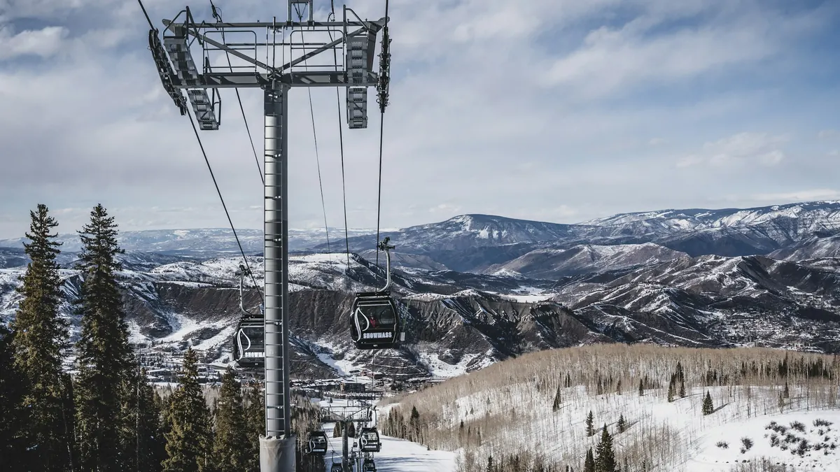 A chairlift tower above snowy mountain slopes near Aspen
